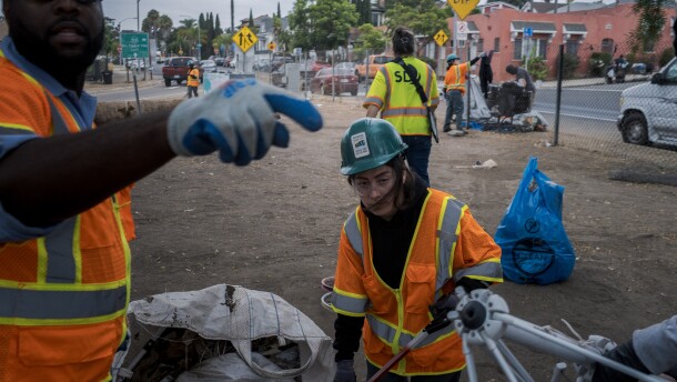 City crews clean up what's left of a homeless encampment near 19th and L Streets in San Diego on Friday, Aug. 15, 2025.