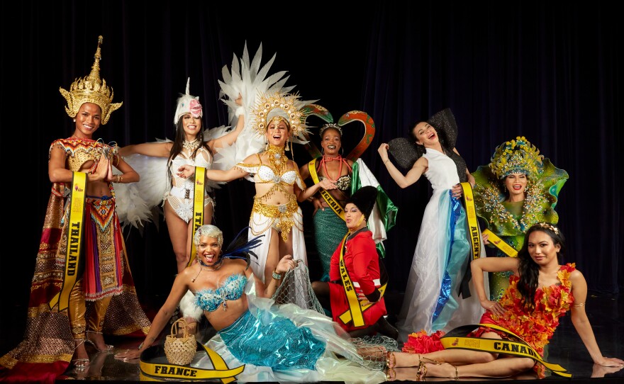 Miss Trans Global's contestants pose in their national costumes. Chedino said her feet were causing her so much pain that she'd returned to her dressing room to rest and missed out on the final group photo.