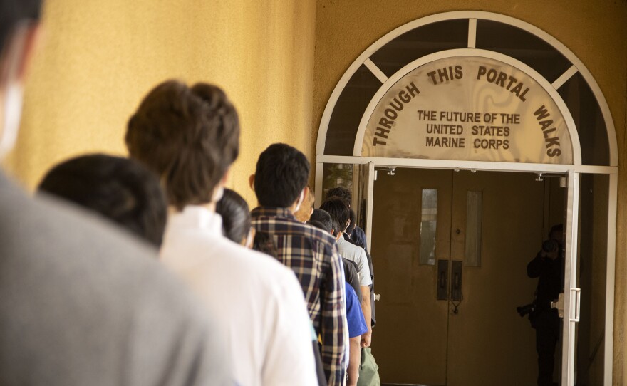Recruits preparing to go through the silver double door at Marine Recruit Depot San Diego as a symbolic transition from civilian life to military life, Feb. 9, 2021.