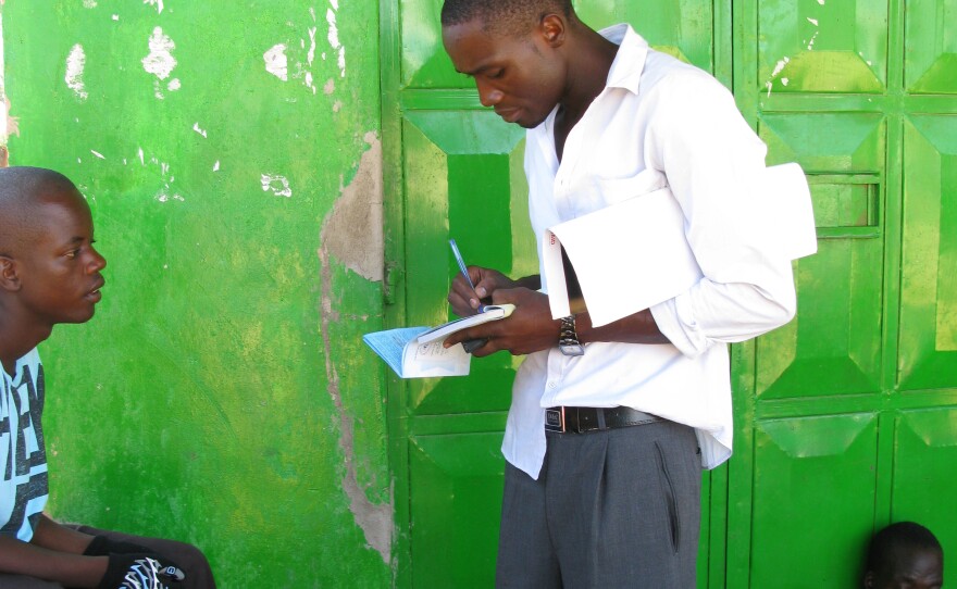 A health worker in western Kenya talks to young men about the benefits of male circumcision.