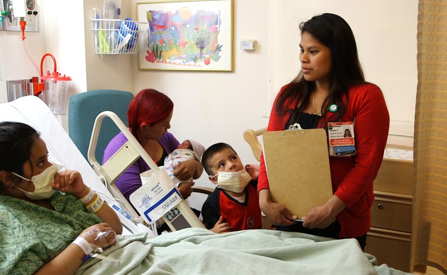 Before becoming an interpreter at Natividad Medical Center in Salinas, Calif., Brigida Gonzalez, right, worked in the strawberry fields.