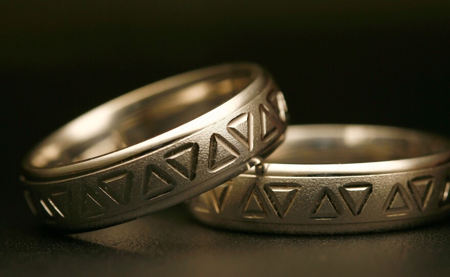 Same-sex wedding rings are engraved with triangles, a symbol of gay pride. Detractors say extending recognition to same-sex couples will weaken a bedrock institution meant to protect women and children.