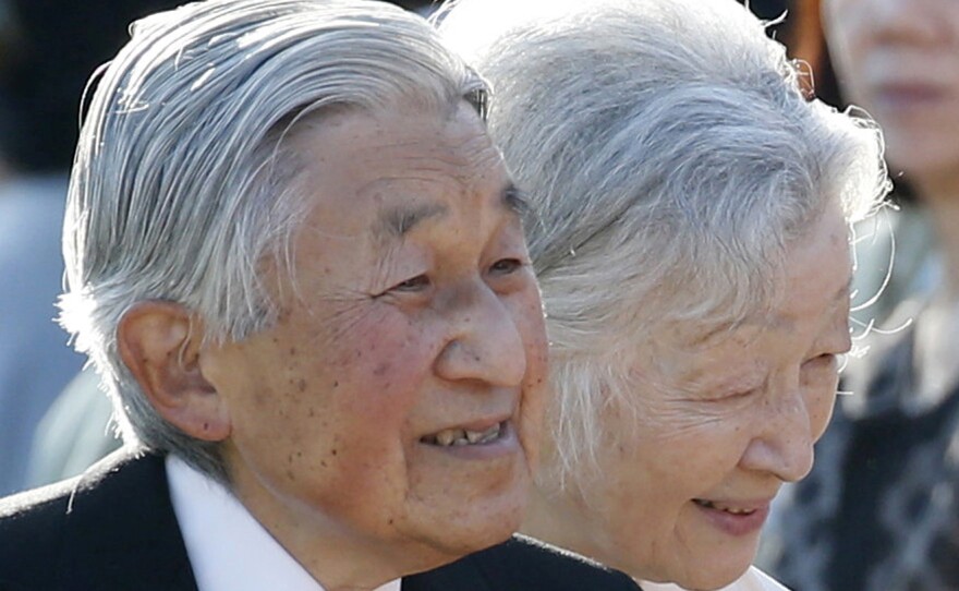 Japan's Emperor Akihito, left, and Empress Michiko, greet guests during the annual autumn garden party at the Akasaka Palace imperial garden in Tokyo earlier this month.