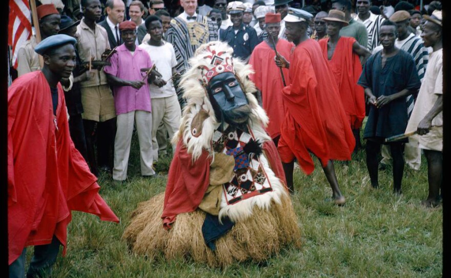 In an image from 1964, a country devil and his attendants prepare for a procession in Lofa County Liberia.