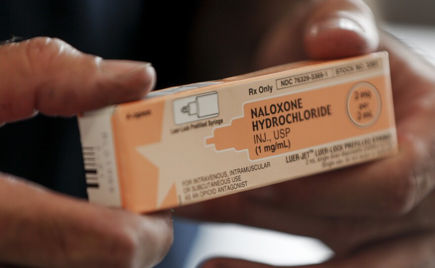 Akron fire medic Paul Drouhard shows a box containing naloxone hydrochloride, a drug carried in all their department emergency response vehicles to treat opioid overdose patients.