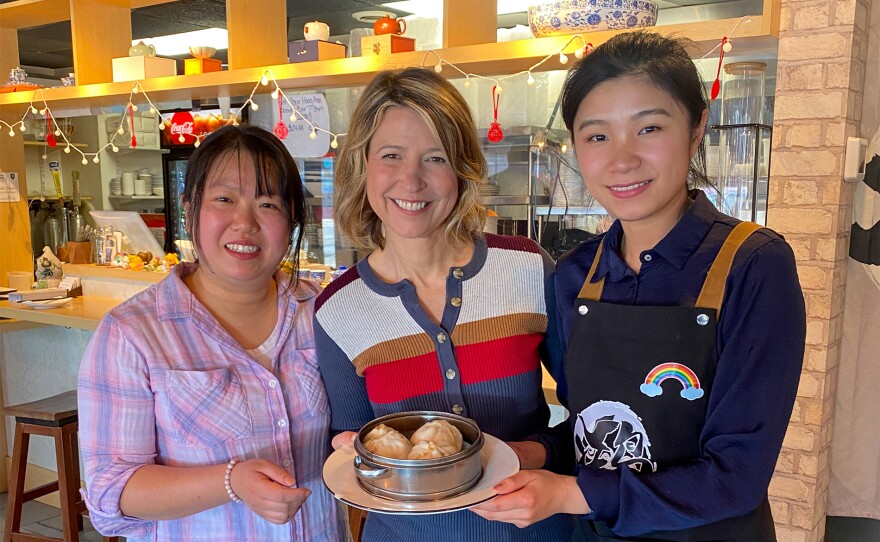 In Dover, Samantha (center) is taught the fine art of making authentic dumplings at Hong Asian Noodle Bar where three friends created a restaurant serving the food they grew up with in China.
