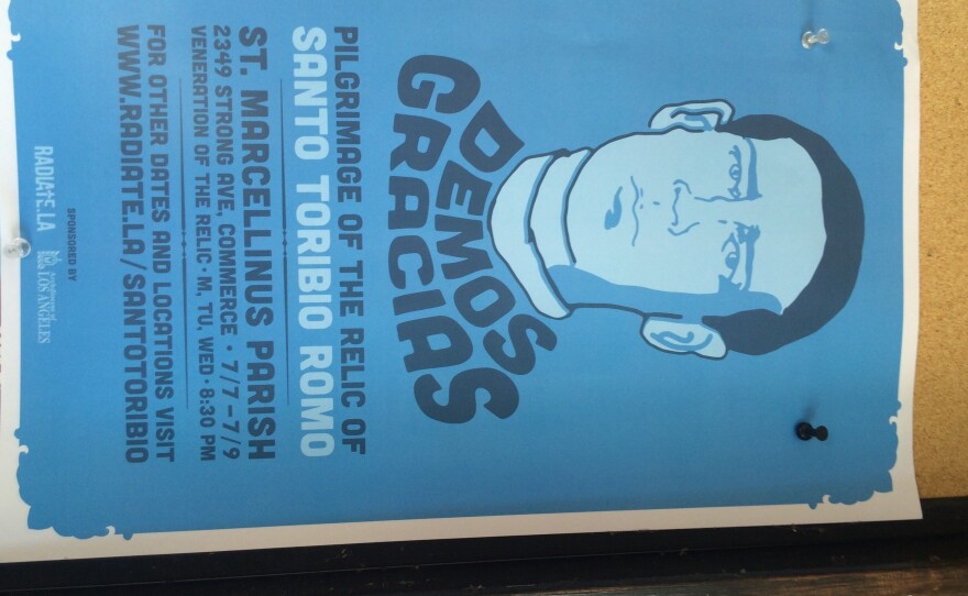 A poster advertises the pilgrimage of the relic of Santo Toribio Romo.