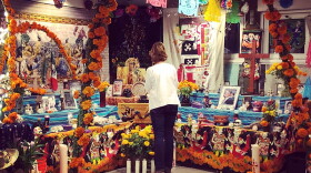 A woman views a Day of the Dead altar at the Sherman Heights Community Center on Nov. 1, 2019.  