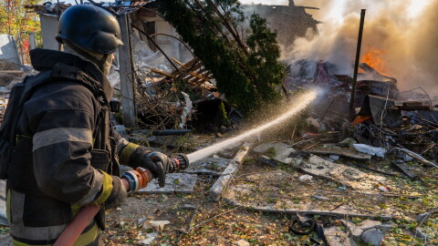 A rescue worker puts out a fire at residential houses destroyed in a Russian strike on Kharkiv, Ukraine, Sunday, Oct. 11, 2026.