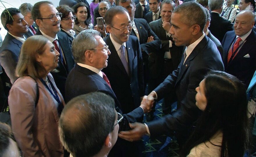 A handout video grab picture provided by the Panamanian Presidency shows President Obama shaking hands with his Cuban counterpart Raul Castro.