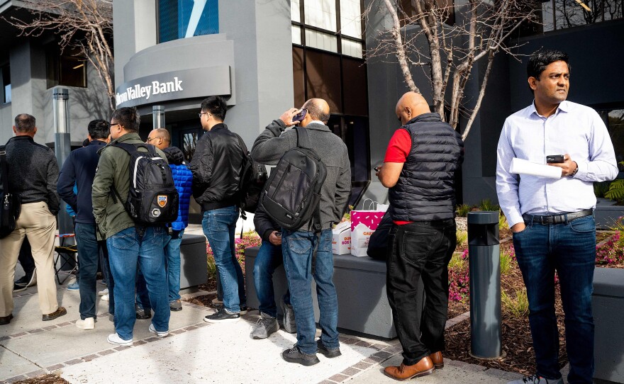 Silicon Valley Bank customers wait in line in Santa Clara, Calif. on March 13 after regulators took over the collapsed bank.