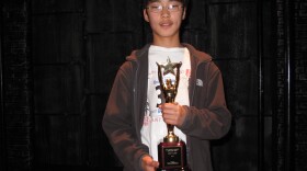 Alex Kahng, 14, holds up his trophy after spelling his way to victory in the San Diego County Spelling Bee Championship at the Old Town Theater on March 25, 2010.