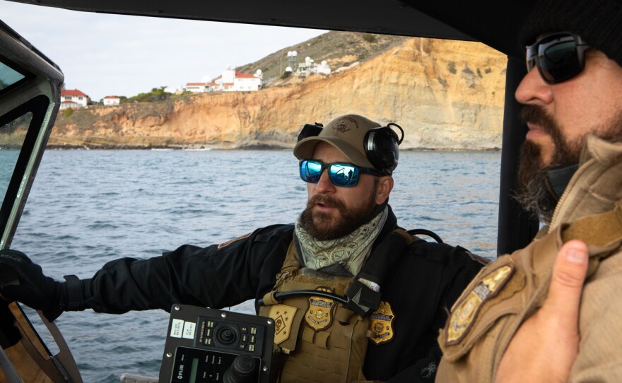 Marine Interdiction Agents Kurt Nagel, left, and Elias Palma operate a boat near Sunset Cliffs for the Customs and Border Protection Air and Marine Operations, Nov. 30, 2022.