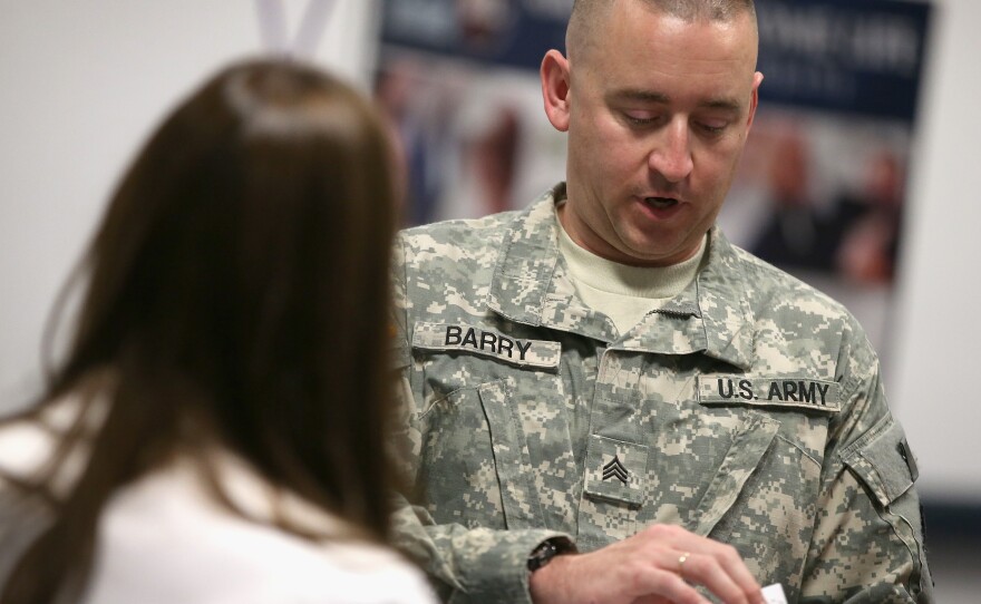 Army National Guard Sgt. Troy Barry speaks with Katie Sogar of Rivers Casino during a job fair for veterans in September.
