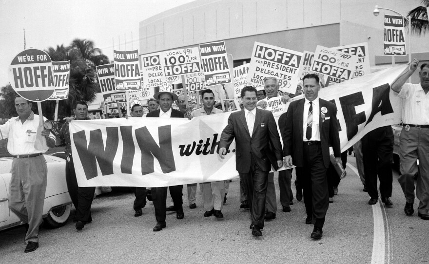 Hoffa, walking at left in front, leads a parade of supporting delegates to the Teamsters Union Convention in Miami Beach in 1957.