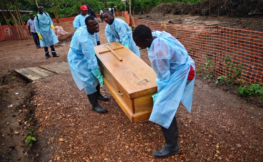 In Sierra Leone, a burial team from the government carries the coffin of an Ebola doctor who succumbed to the virus. Funerals and other expressions of mourning are key moments for anthropologists to translate between native cultures and foreign aid efforts, anthropologist Ann Kelly says.