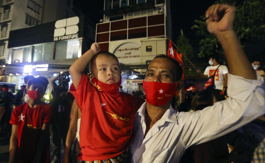 Supporters gather in front of Aung San Suu Kyi's National League for Democracy headquarters on Sunday, in Yangon, Myanmar.