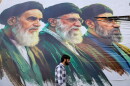 A man walks past a billboard featuring the portraits of (right to left) Iran's new Supreme Leader Ayatollah Mojtaba Khamenei, the late Supreme Leader Ayatollah Ali Khamenei, and the late Supreme Leader Ayatollah Ruhollah Khomeini, in Srinagar, Jammu and Kashmir, on June 15.