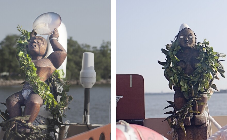 Ki'i, statues that help guide the vessel, are on either side of the boat. Only the female (right) has eyes because she sees the way while the male counterpart stands guard.