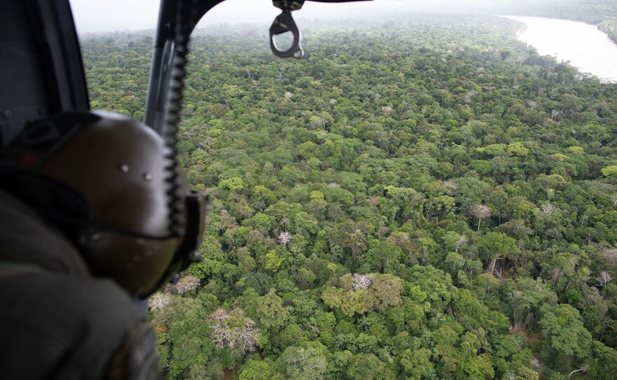 In this aerial view, a Brazilian helicopter patrols an area of the municipality of Atalaia do Norte,  Brazil, in the direction of the Itaquaí River, in the search for missing men Bruno Pereira and Dom Phillips, on June 10.
