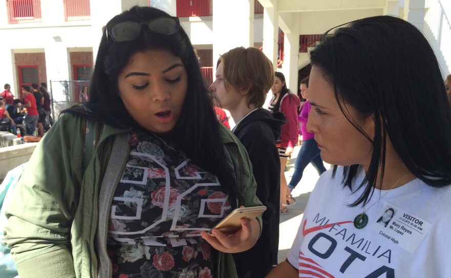 Mairy Reyes (right), a civic engagement officer with the non-profit group Mi Familia Vota, registers students to vote at Colonial High School in Orlando.