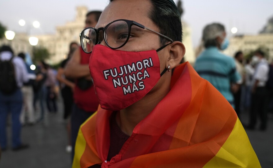 A young man wears a mask protecting against COVID-19 that reads in Spanish "Fujimori never more," as demonstrators protest against the decision of Peru's Constitutional Court approving the release from prison of former President Alberto Fujimori in Lima, Peru on Thursday.
