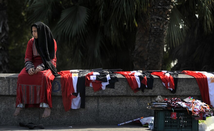 A young woman sells Egyptian flags in central Cairo on Monday. Voters are scheduled to go to the polls on Saturday for a referendum on proposed constitutional amendments.