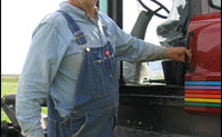 Cecil Garland climbs into his swather, which he uses to cut hay on his Callao, Utah, ranch.