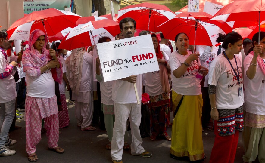 Activists at a rally urge China, Germany and Japan to step up their contributions to the Global Fund to fight AIDS, tuberculosis and malaria, in New Delhi, India, on May 10.