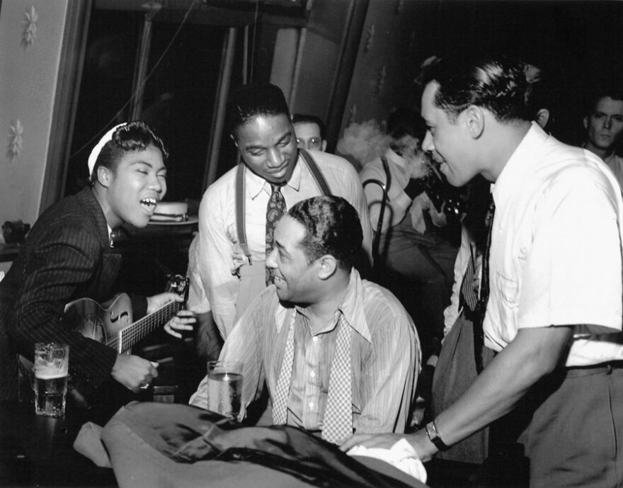 Sister Rosetta Tharpe with Duke Ellington (at piano) and Cab Calloway, with trombonist J.C. Higginbotham ad trumpeter Hot Lips Page looking over the Duke’s shoulder, taken in 1939.