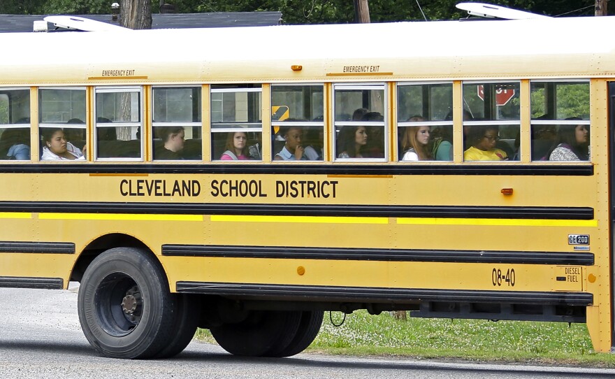 Public school students in Cleveland, Miss., ride the bus on their way home following classes in May 2015.
