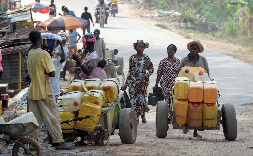 Street vendors sell water on a street of Gueckedou — the city in Guinea where the Ebola outbreak began. Bordering Sierra Leone and Liberia, Gueckedou is a bustling city of more than 200,000 people.