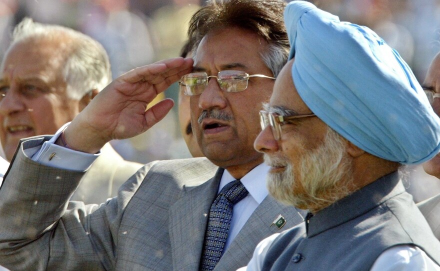 In 2005, Pakistan's President Gen. Pervez Musharraf salutes spectators as Indian Prime Minister Manmohan Singh (right) looks on during a cricket match between India and Pakistan in New Delhi. The two leaders later held talks on how to end decades-old hostilities.