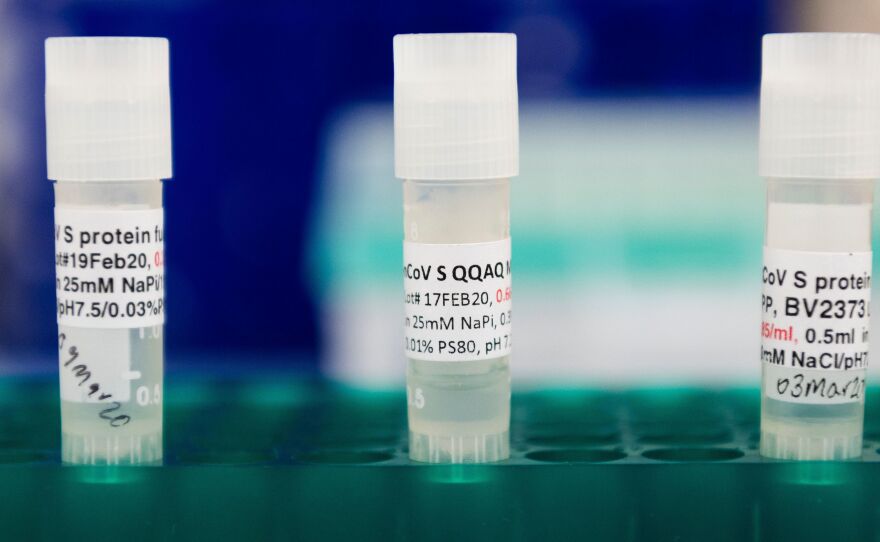 Three potential coronavirus vaccines are kept in a tray at Novavax labs in Gaithersburg, Md., in March 2020. The company has moved into phase 3 trials in the U.K.