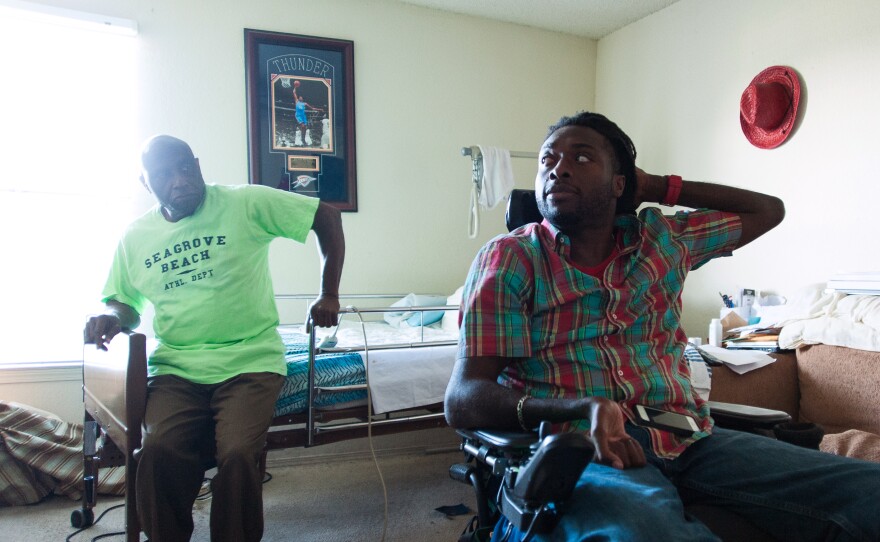 Nnaka and his father, Phillip, chat in Emeka's room.