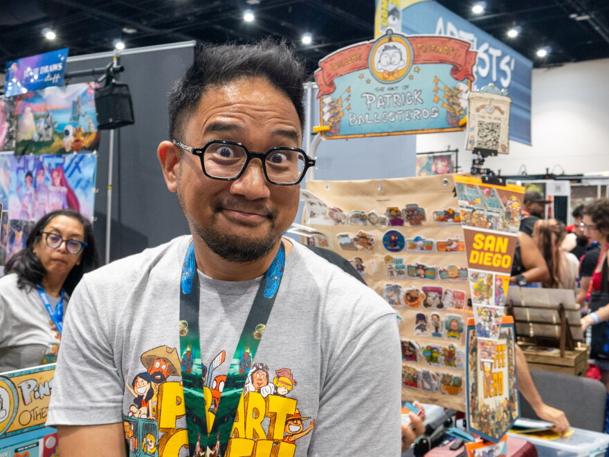 Patrick Ballesteros poses for a photo in front of his Comic-Con booth on July 23, 2026.
