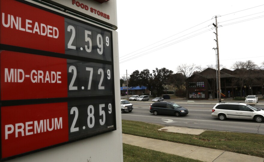 The lowest gas prices in years are seen on a fuel sign in Lawrence, Kan., on Wednesday. OPEC today decided to maintain current production levels, virtually ensuring continued low prices at the pump.