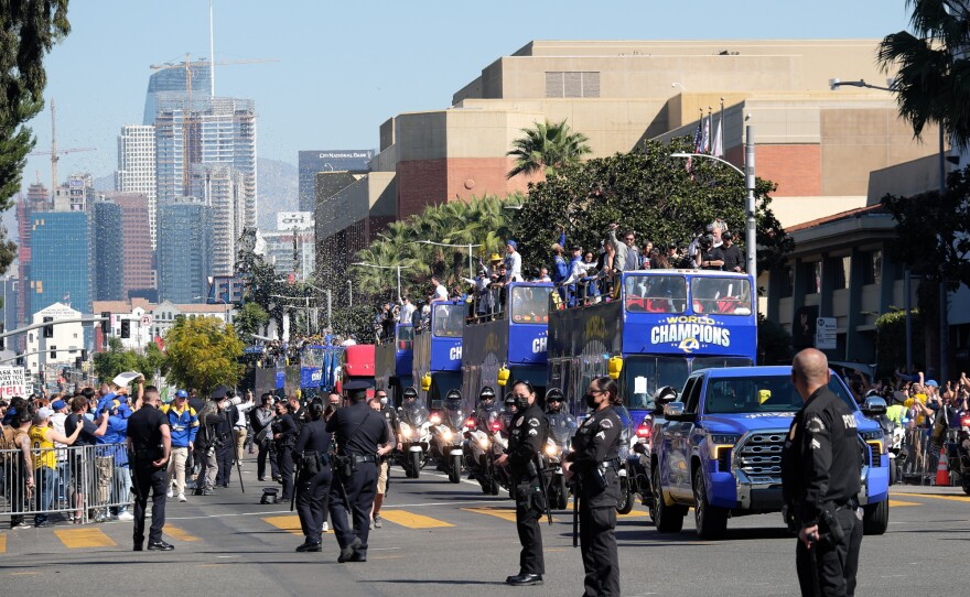 Police stand by as people celebrate at the Los Angeles Rams' Super Bowl victory parade and rally on Feb. 16.