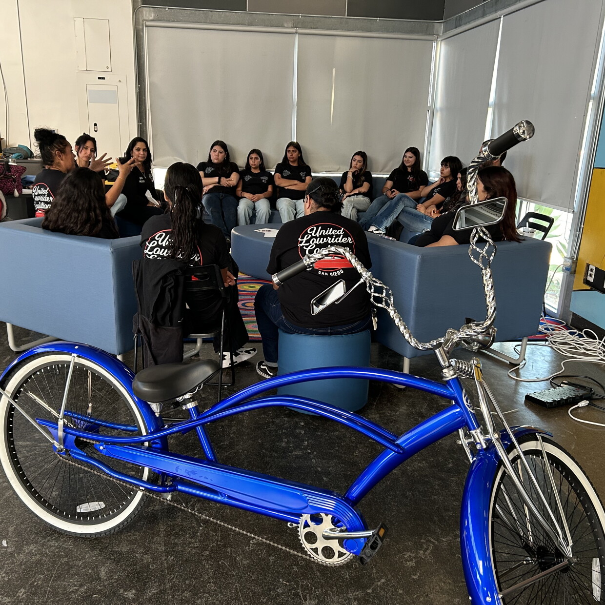 Mentors with the United Lowrider Youth Leadership Bike Club speak to students in the program on April, 28, 2026.