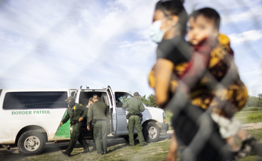 Central American migrants are apprehended by U.S. Customs and Border Protection agents after crossing the Rio Grande in LaJoya, Texas, on June 12, 2021.