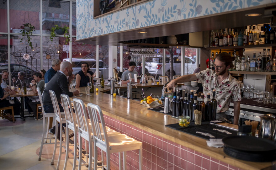 A bartender pours a drink at L'Oca d'Oro, an Italian restaurant in Austin, Texas, that offers a weekly promotion where guests can pay what they want.