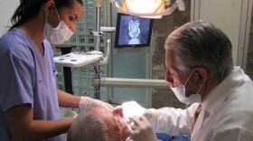 Dr. Bernardo Magaña and his assistant examine a foreign patient in Magaña's office in Los Algodones, Mexico. Dr. Magaña opened his practice in Los Algodones in 1969.
