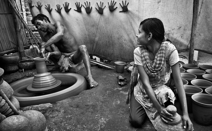 Third place: A teen girl helps her father in their pottery business in West Bengal, India.