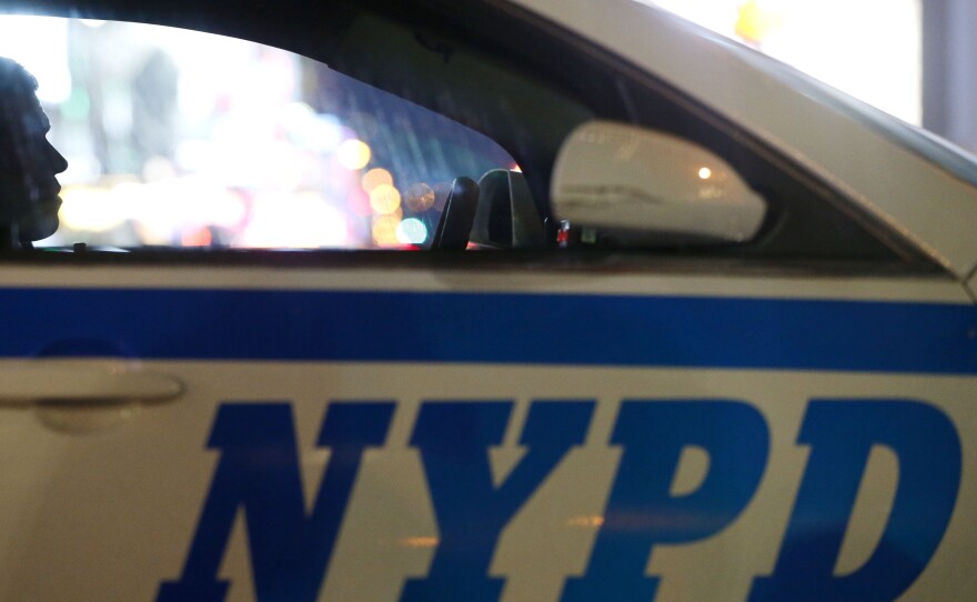 In this Dec. 31, 2015, file photo, a New York City police officer sits in a cruiser at a checkpoint surrounding Times Square.