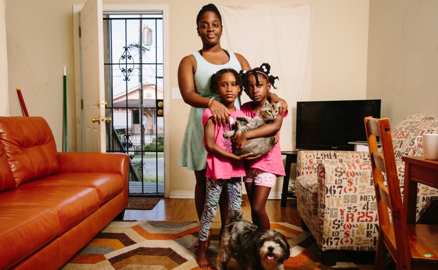 Dyha Gresham (front, left), her older sister Briceshanay (in back) and Briceshanay's daughter Uri stand in their New Orleans home with the family's cat Sugar-Pepper and dog Selena. After Katrina, Briceshanay says, she relied on theater and the arts to help her "move through terrible and difficult times."