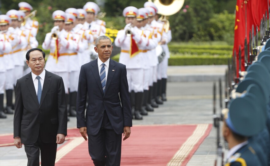 President Barack Obama walks with Vietnamese President Tran Dai Quang as they review a guard of honor during a welcoming ceremony at the Presidential Palace in Hanoi on May 23.