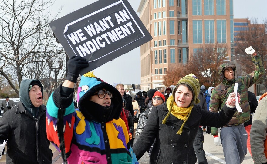 Protesters march in Clayton, Mo., Monday. Gov. Jay Nixon declared a state of emergency and activated the National Guard ahead of a grand jury decision in the case of Michael Brown, a black teenager shot and killed by a white police officer in August.
