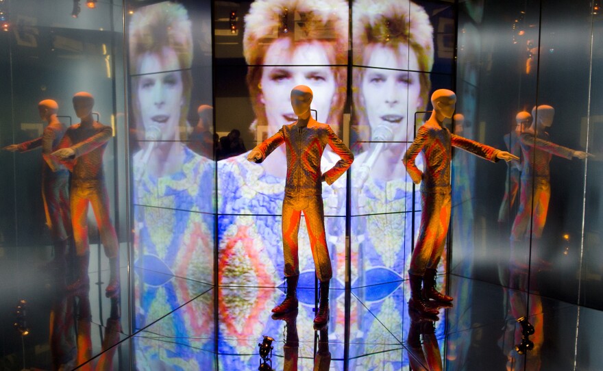 The "Starman" costume from David Bowie's appearance on "Top of the Pops" in 1972 is displayed at the "David Bowie is" exhibition at the Victoria and Albert museum in London on March 20, 2013. The exhibition featured more than 300 objects, including handwritten lyrics, original costumes, fashion, photography, film, music videos, set designs and Bowie's own instruments.