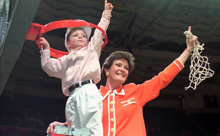 Tennessee coach Pat Summitt and son Tyler, 5, take down the net after the Lady Vols won the NCAA women's Division I title in Charlotte, N.C, on March 31, 1996.