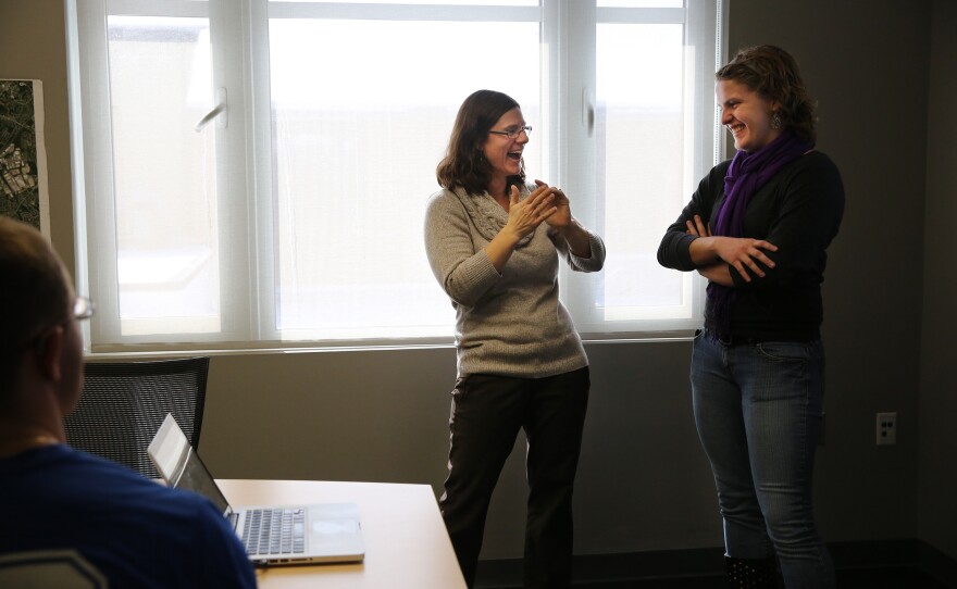 Solomon gives a student advice on a lab presentation.